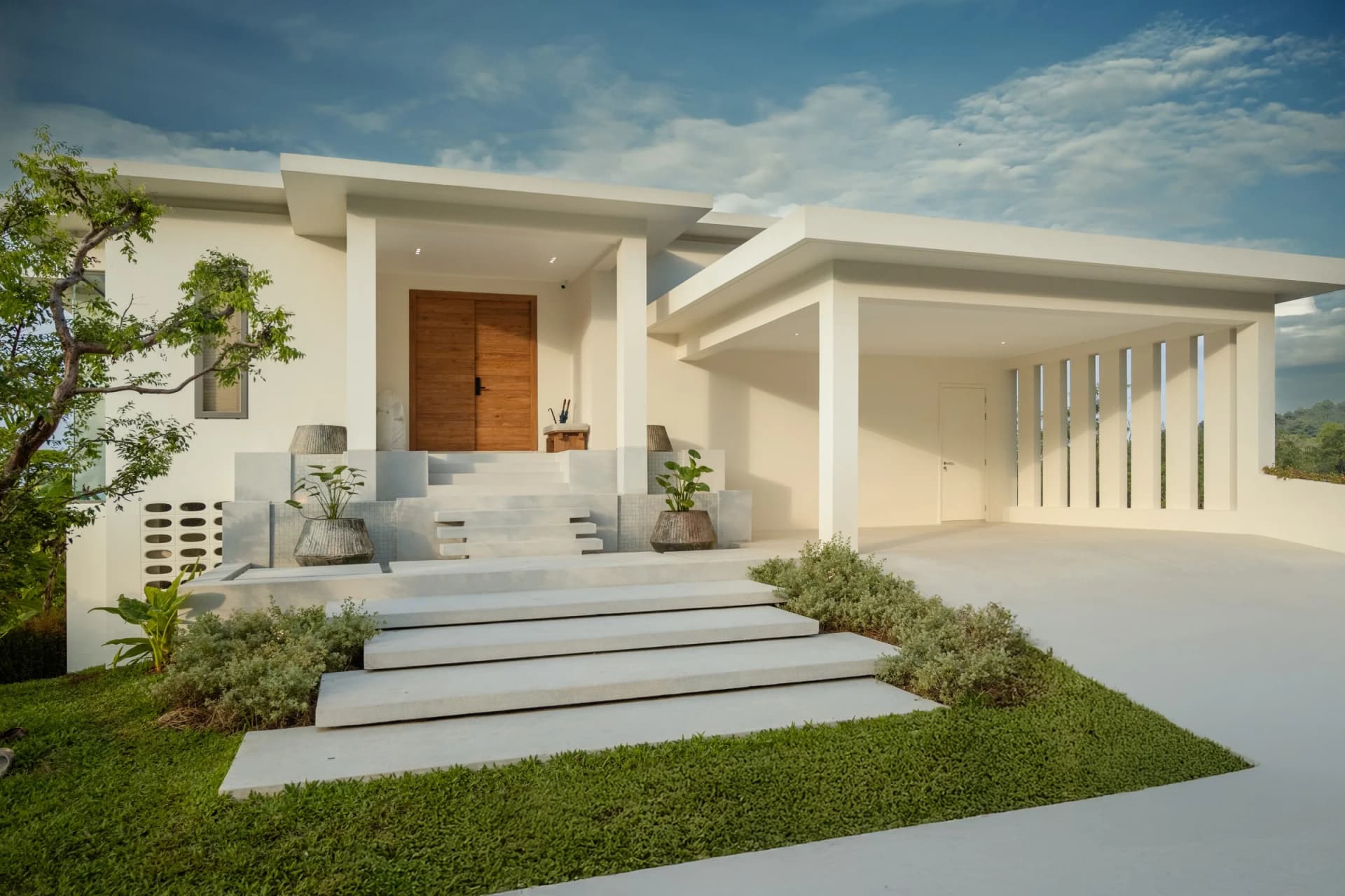 Entrance of finished villa 15: stone steps through the lawn to the front door